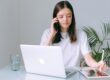 a saleswoman applying some calling tecniques in her sales routine with a laptop and an Ipad in front of her